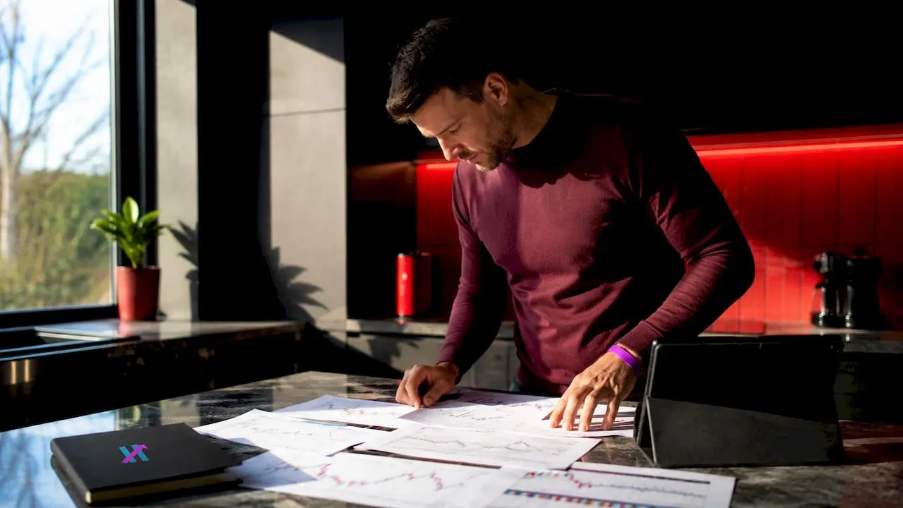 Trader reviewing trade signals at home desk