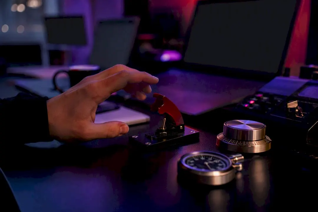Hand reaching manual override switch on trading desk