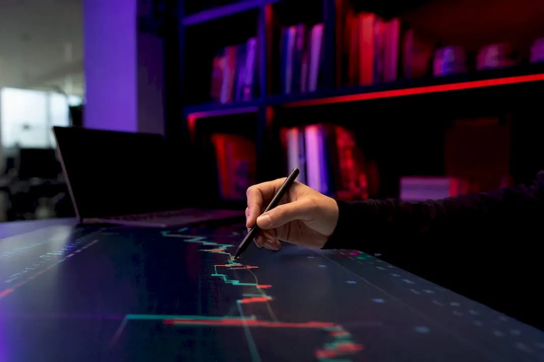 Hands pointing at trading chart details
