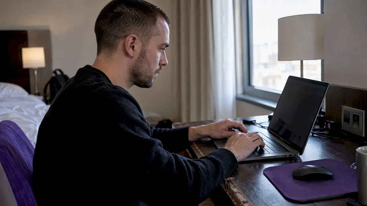Trader configuring a bot alert on laptop