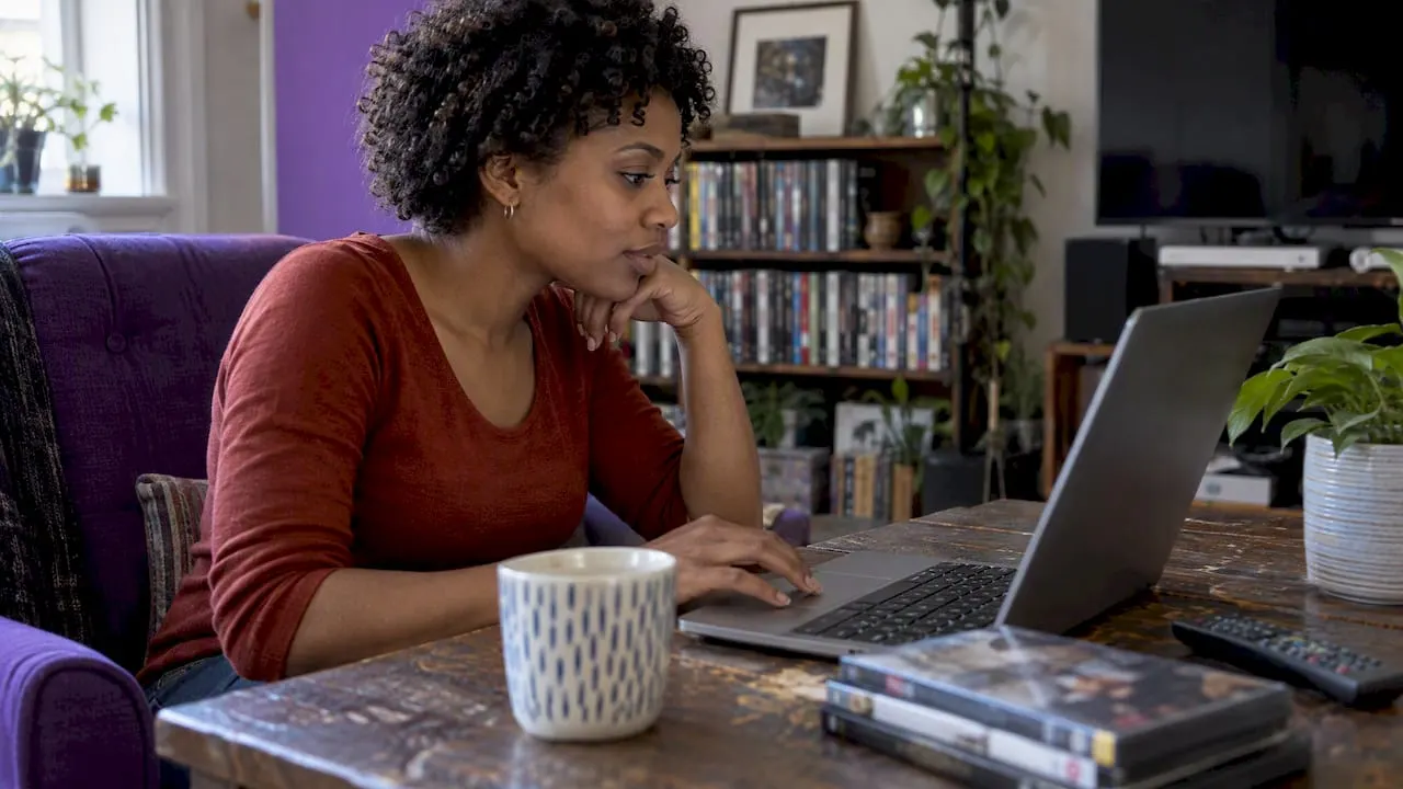 Woman comparing film ratings on laptop